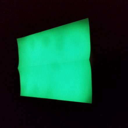 Charged Atomic Glow in Green